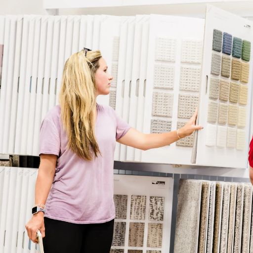 Women holding flooring sample in floor store 