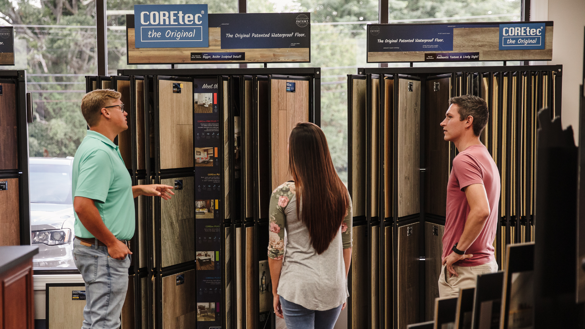 COREtec Luxury vinyl flooring display with salesperson and customer discussing product