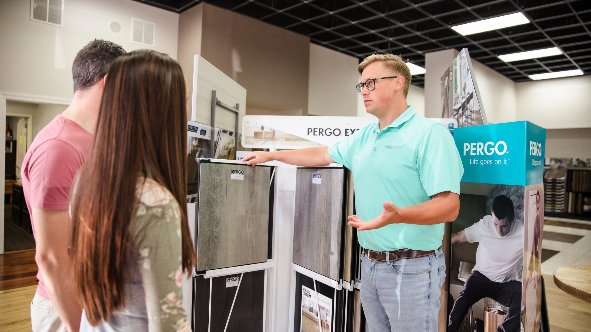 Laminate flooring display with salesperson and customer discussing product
