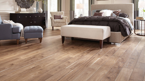warm toned wood look laminate flooring in a classy bedroom